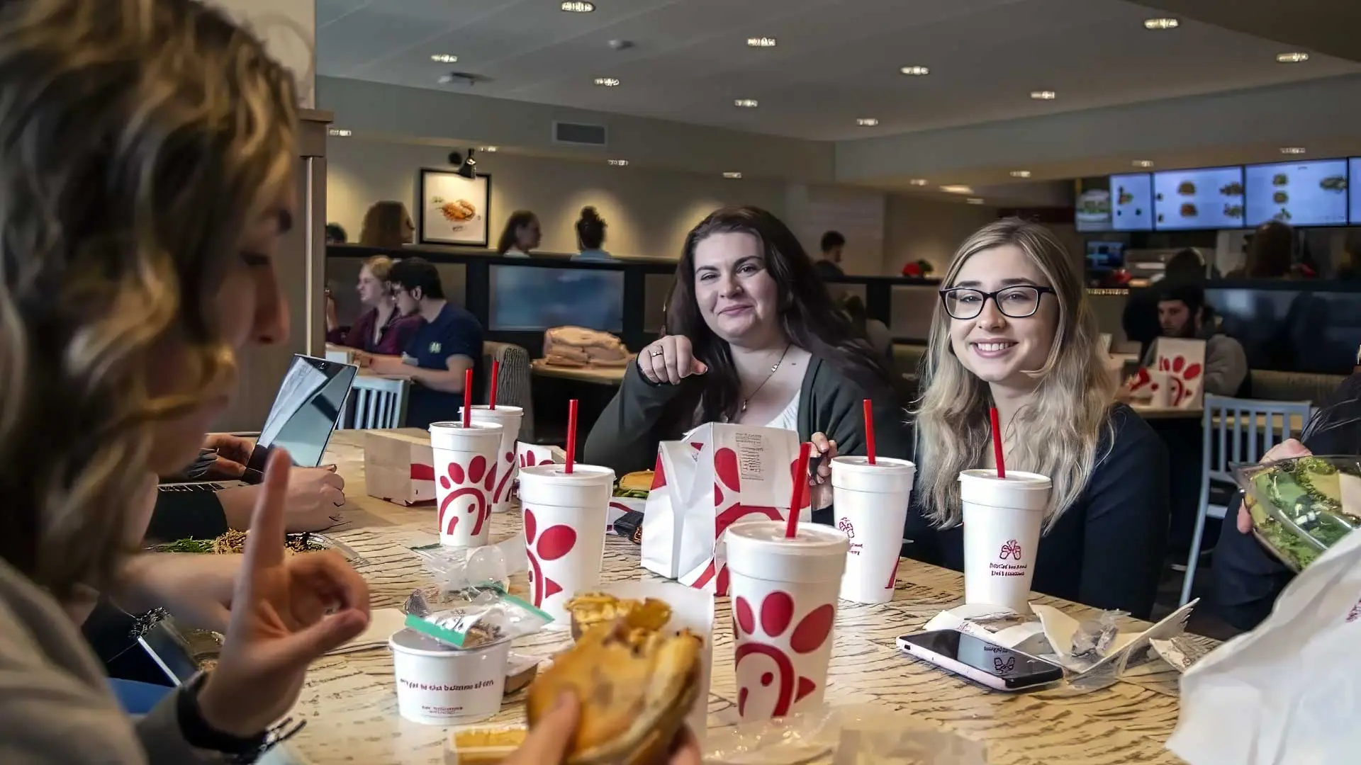 Students eating and enjoying conversation inside of Chick-fil-A