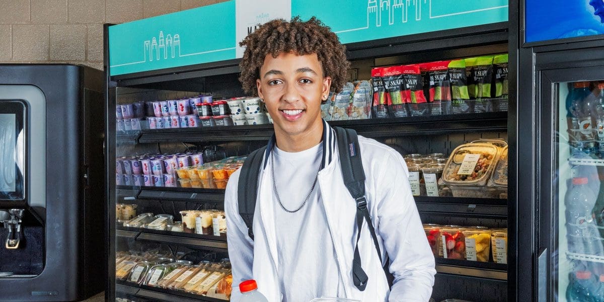 Smiling student inside of campus c-store