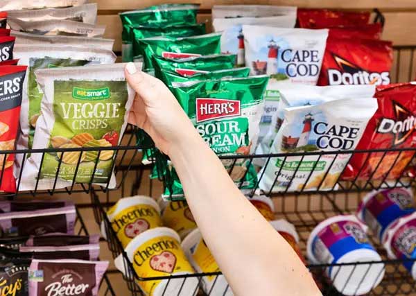Hand grabbing bag of chips